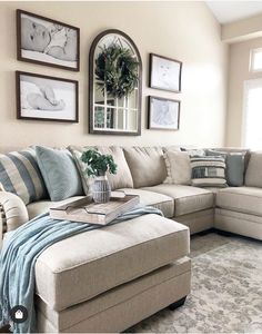 a living room filled with furniture and pictures on the wall