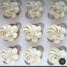 twelve cupcakes with white frosting and crystal decorations