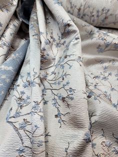 an up close shot of a blue and white floral print fabric