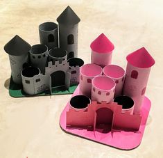 several paper castles sitting on top of a white table next to each other and one is pink