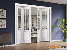 a living room with blue walls and white french doors