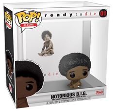 a pop vinyl figure in a box with an image of a boy on the floor