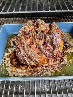 a large piece of meat sitting on top of a blue plate next to an oven