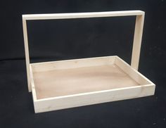 an empty wooden box with no lid on a black background, showing the bottom section