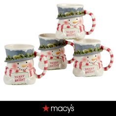 four snowman mugs sitting next to each other