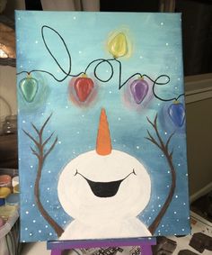 a snowman painting with fruit on it and the word love written in large letters