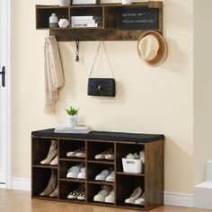 a wooden shelf with shoes and hats on it next to a white door in a room