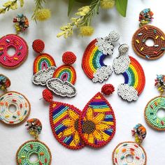 a bunch of beaded items sitting on top of a table next to some flowers