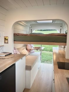 the interior of a tiny home with a kitchen and living area in it, as well as a bed