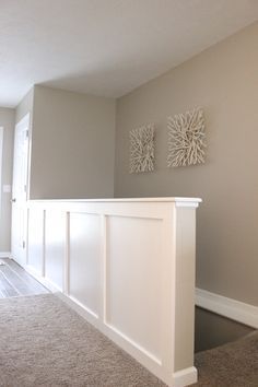 an empty living room with carpeted flooring and white walls