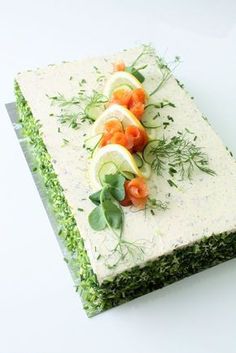 there is a cake with cucumbers and carrots on it