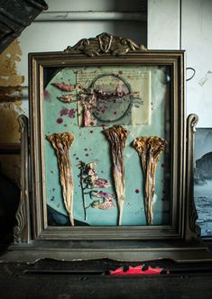 an old frame with some dried flowers in it