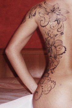 the back of a woman's body with flowers on it