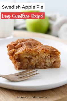 a piece of apple pie on a white plate with a fork and glass of milk in the background