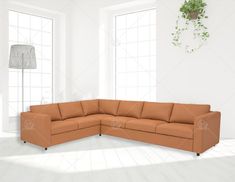 a living room with an l - shaped couch and potted plant