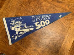 an indy 500 pennant sitting on top of a wooden table