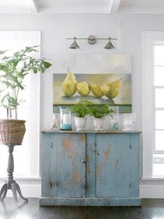 a blue cabinet sitting next to a potted plant