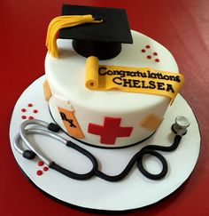 a cake with a stethoscope and graduation cap on it