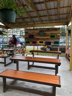 an outdoor picnic area with benches and potted plants