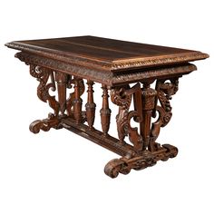 an old wooden table with ornate carvings on the top and bottom, against a white background