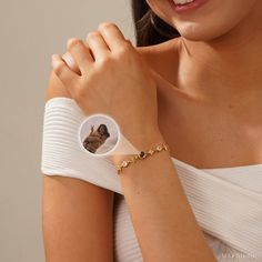 a woman wearing a bracelet with a photo on it