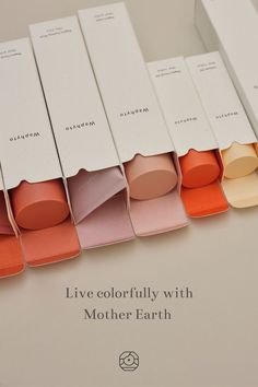 six different shades of lipstick in boxes with the words live colorfully with mother earth