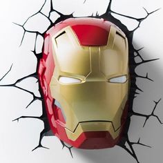 an iron man mask is shown through the cracked wall