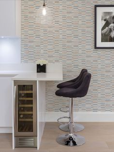 a modern bar stool in front of a wine rack