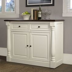 a white cabinet with two wine glasses on top