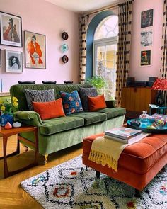 a living room filled with lots of furniture and pictures on the wall above it's windows