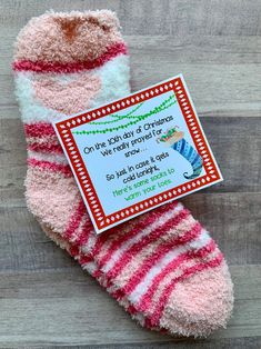 a pink and white striped sock with a card on it