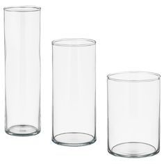 three clear glass vases sitting next to each other on a white surface with measurements