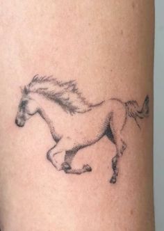 a black and white horse tattoo on the leg