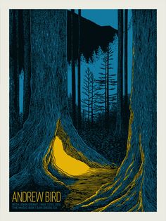 an image of a yellow light in the middle of a forest with trees on both sides