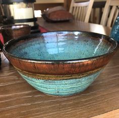 two bowls sitting on top of a wooden table