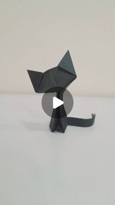 an origami cat sitting on top of a table