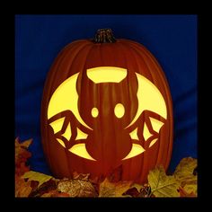 a carved pumpkin with an image of a bat on it