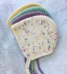 a multicolored crocheted hat with tassels