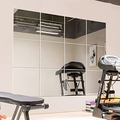 an exercise room with treadmills and mirrors