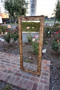 a mirror sitting on top of a brick walkway