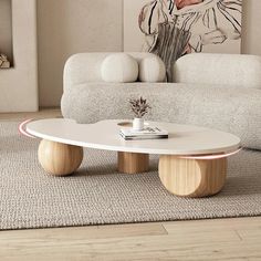 a living room with white couches and a coffee table in the middle of it