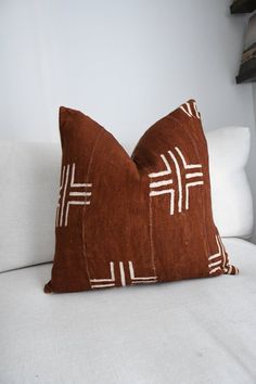 a brown pillow sitting on top of a white couch