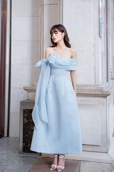 Possesses a basic dress form that helps to flatter the curves of the body A very simple but extremely poetic design with a drop shoulder design, knotted to create a lovely bowtie. Pastel blue tones express pure, gentle beauty, bringing a sense of peace. Product Details - Product type: Midi Dress- Material: Organza, Taffeta- Draped off-shoulder - Big bowtie at the shoulder - Fitted waist - A-line skirt - Length: 115cm Size & Fit - Model wears size: S- Model measurement: 170cm, 86-62-88 Care Instr Beautiful Dps, Bowtie Dress, Bow Tie Dress, Mean Blvd, Pastel Dress, Bow Dress, Stylish Dress Book, Basic Dress, Glam Dresses