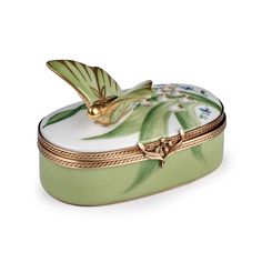 a green and white box with a butterfly on it's lid, sitting in front of a white background