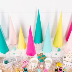 there are many different colored cones on the table