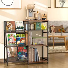 there is a book shelf in the living room with books on it and pictures above