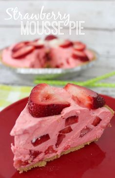 a slice of strawberry cheesecake on a red plate with the rest of the pie in the background