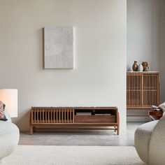 a living room filled with furniture and a painting on the wall