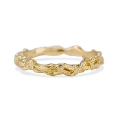 a yellow gold ring with twisted branches on the outside, and a small diamond in the middle