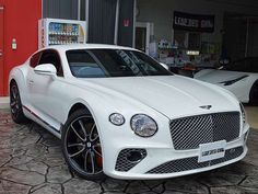 a white car parked in front of a building